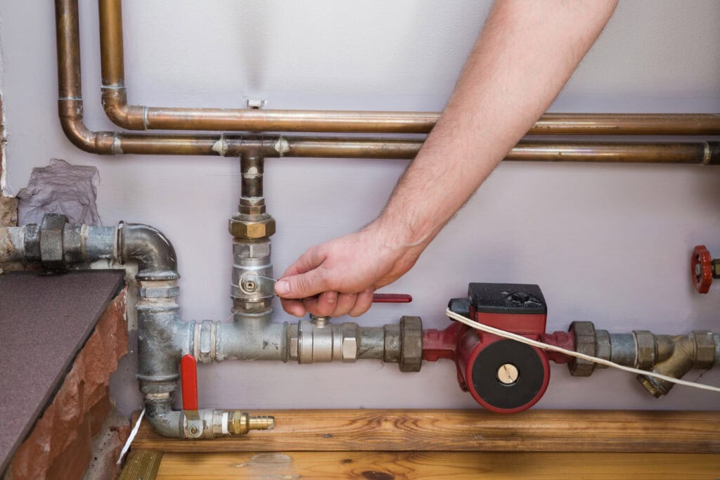 Why your estate agency needs a dedicated boiler engineer (and not just any one will do) 1 Man,Working,At,Pipes.,Employee's,Hand,Turning,On,Or,Turning